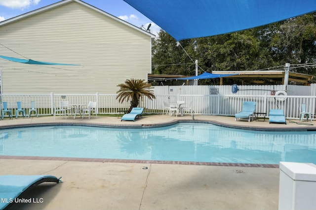 view of swimming pool with a fenced in pool, a patio, and fence