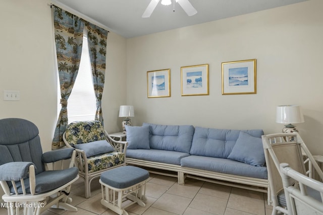 living area featuring light tile patterned floors and a ceiling fan