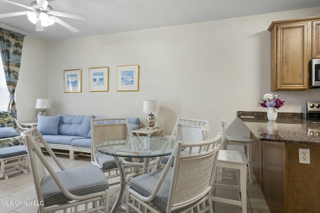 dining area with light tile patterned floors and a ceiling fan