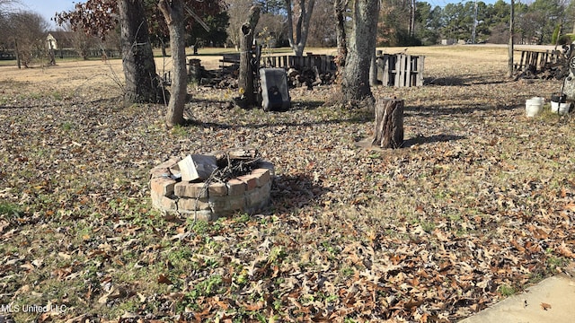 exterior details featuring an outdoor fire pit