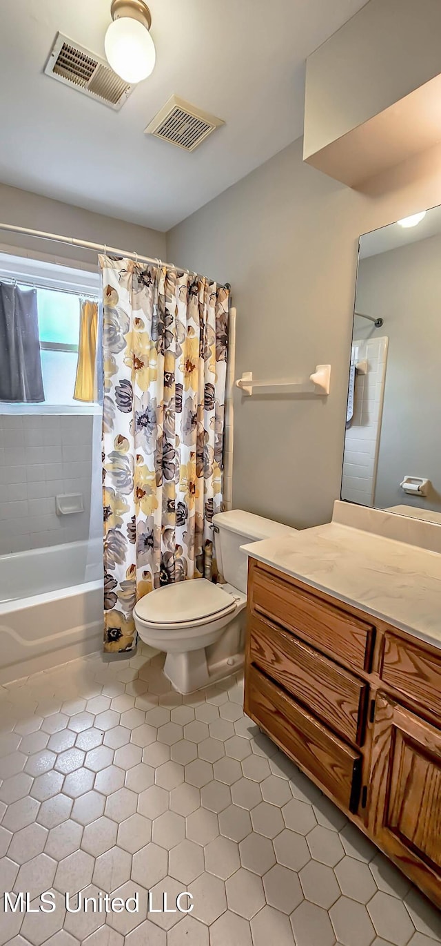 full bathroom with tile patterned flooring, vanity, toilet, and shower / bathtub combination with curtain