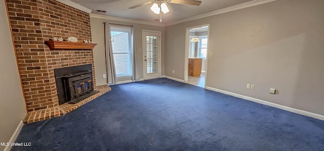 unfurnished living room with dark colored carpet, ceiling fan, ornamental molding, and a wood stove