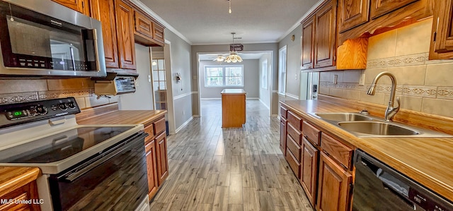 kitchen with backsplash, sink, an inviting chandelier, black dishwasher, and range with electric stovetop