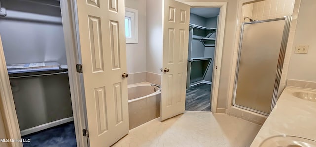 bathroom featuring tile patterned floors, vanity, and separate shower and tub