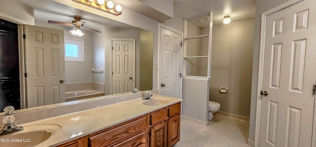 bathroom featuring vanity, tile patterned flooring, ceiling fan, toilet, and a tub to relax in