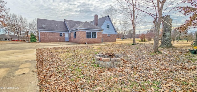 exterior space with a fire pit and a patio area