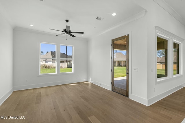 spare room with wood-type flooring, ceiling fan, and ornamental molding