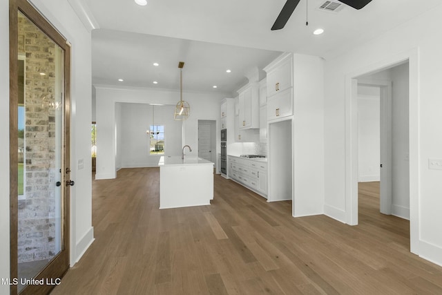 kitchen featuring pendant lighting, dark hardwood / wood-style floors, and white cabinetry