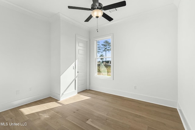 empty room with crown molding, ceiling fan, and light wood-type flooring