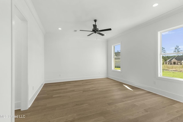 spare room featuring crown molding, ceiling fan, and wood-type flooring