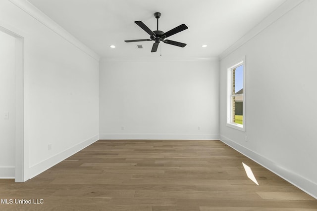 spare room with hardwood / wood-style flooring, ceiling fan, and crown molding