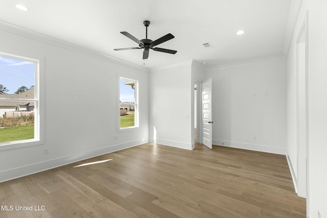 unfurnished room featuring ceiling fan, ornamental molding, and light wood-type flooring