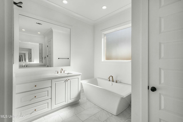 bathroom with vanity, a bathtub, and crown molding