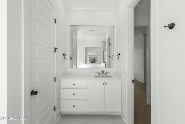 bathroom with vanity, wood-type flooring, and ornamental molding