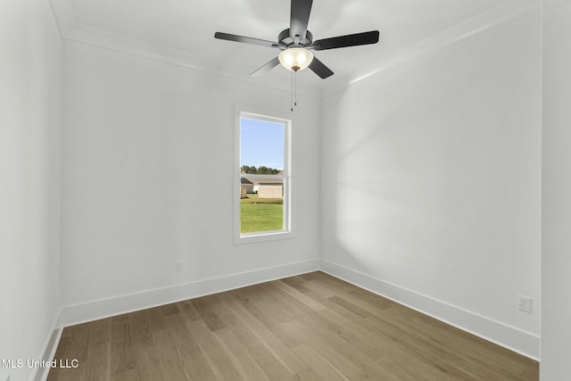 empty room with light hardwood / wood-style floors, ceiling fan, and crown molding