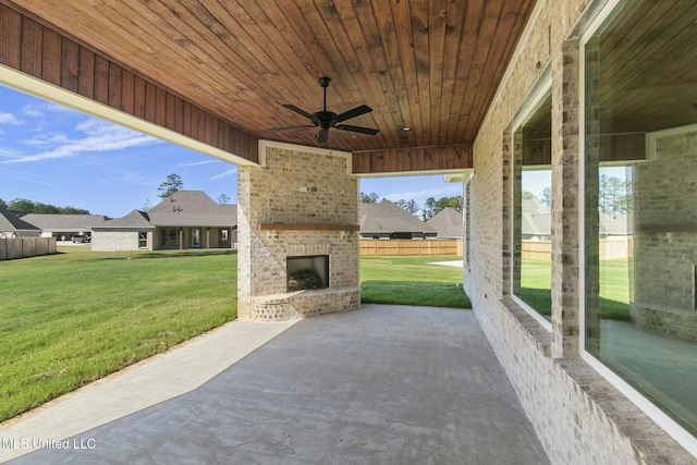 view of patio / terrace featuring an outdoor brick fireplace and ceiling fan