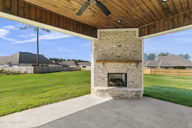 view of patio / terrace featuring an outdoor brick fireplace and ceiling fan