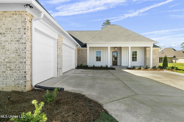 view of front of property with a porch and a garage