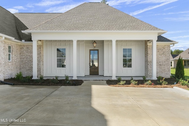 view of exterior entry featuring covered porch