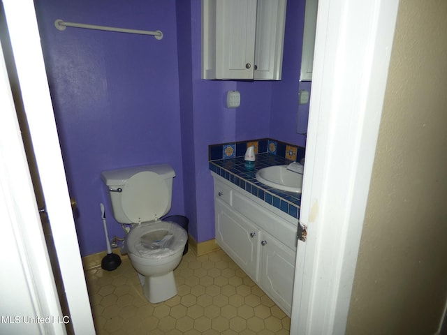 816 Hart Rd, Mccomb, MS 39648 - half bathroom with tile patterned floors, toilet, and vanity