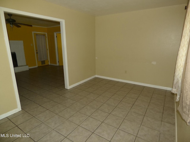 816 Hart Rd, Mccomb, MS 39648 - spare room featuring baseboards, light tile patterned floors, ceiling fan, and a fireplace