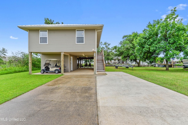 11334 Texas St, Bay Saint Louis, MS 39520 - coastal home featuring a carport, stairway, driveway, and a front lawn