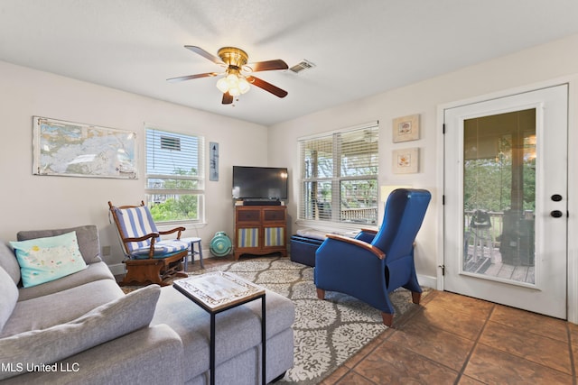 11334 Texas St, Bay Saint Louis, MS 39520 - living room with plenty of natural light, ceiling fan, tile patterned flooring, and baseboards