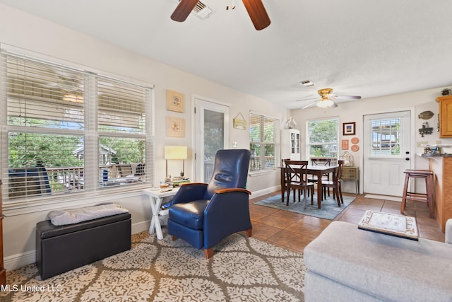 11334 Texas St, Bay Saint Louis, MS 39520 - tiled living area with ceiling fan and baseboards