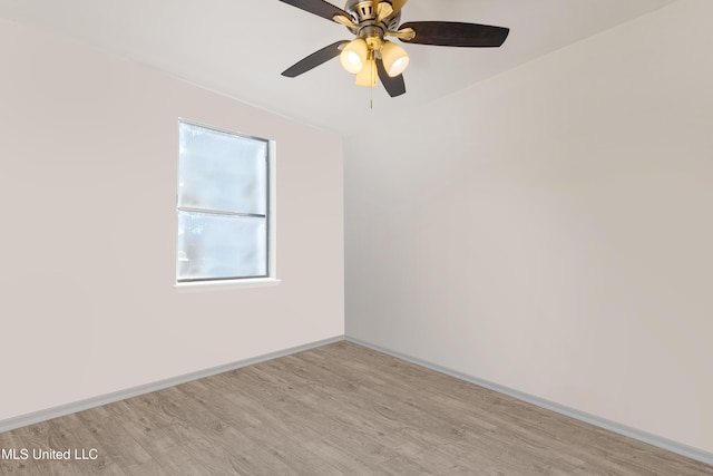 unfurnished room featuring baseboards and light wood-type flooring