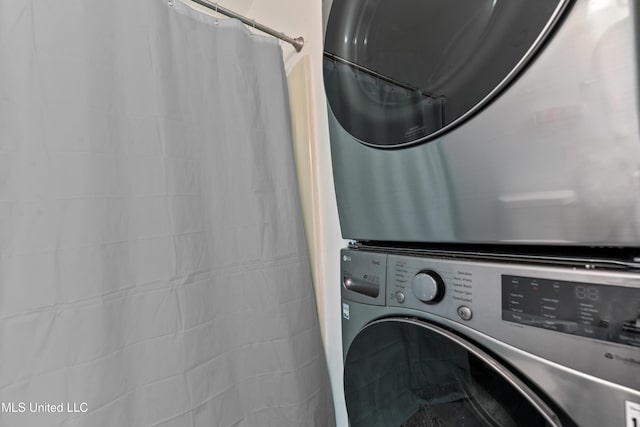 laundry room featuring laundry area and stacked washer and clothes dryer