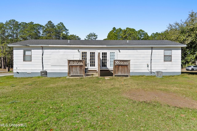 rear view of house featuring crawl space, a lawn, french doors, and cooling unit