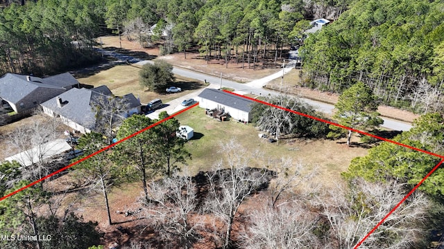 drone / aerial view featuring a forest view