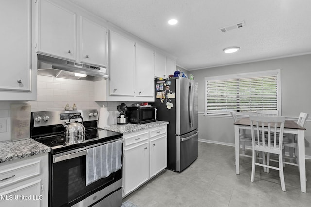 kitchen featuring stainless steel appliances, under cabinet range hood, decorative backsplash, white cabinetry, and a textured ceiling