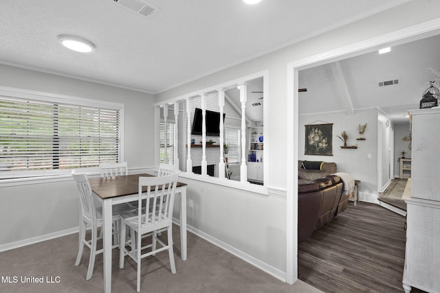 dining room featuring vaulted ceiling and baseboards