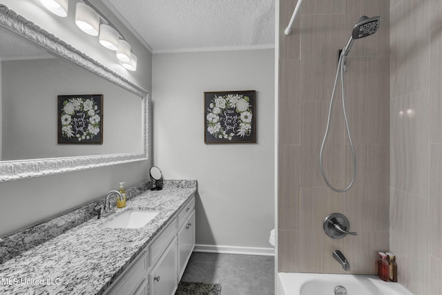 bathroom featuring vanity, a textured ceiling, ornamental molding, washtub / shower combination, and baseboards