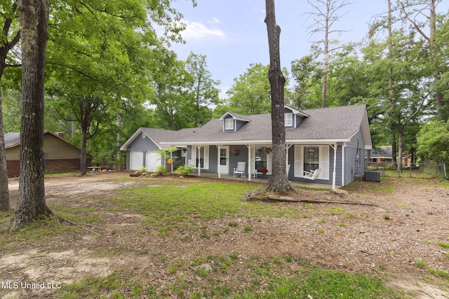 view of front of house featuring covered porch, a garage, central AC, driveway, and fence