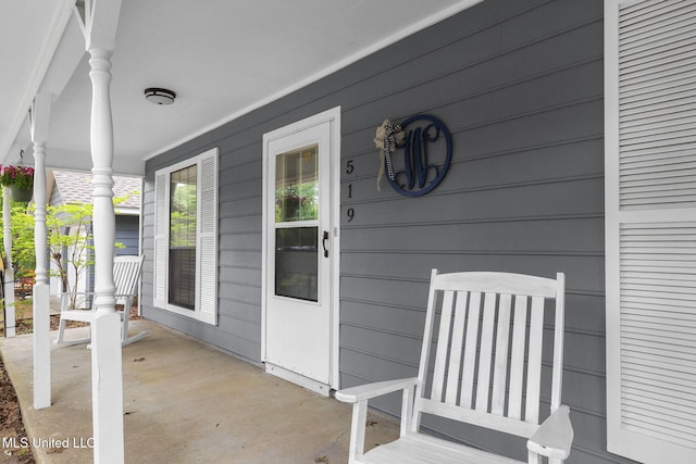 view of exterior entry with covered porch