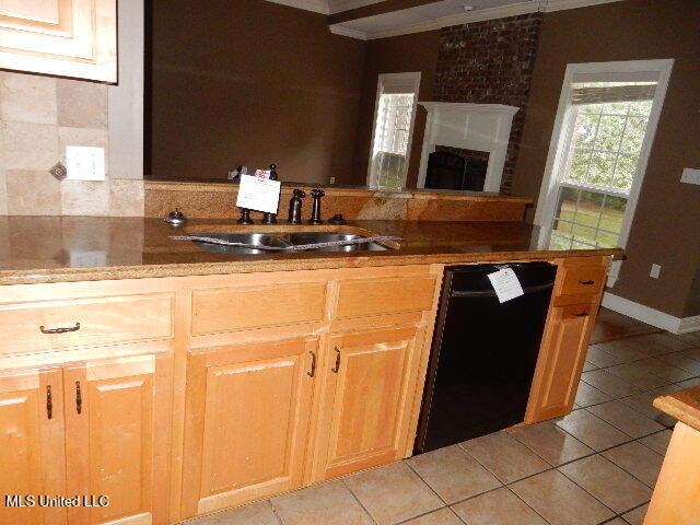 8 Auburn Ln, Hattiesburg, MS 39401 - kitchen featuring dishwasher, a sink, light tile patterned floors, crown molding, and tasteful backsplash