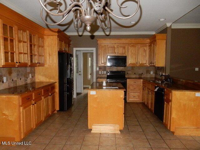 8 Auburn Ln, Hattiesburg, MS 39401 - kitchen with black appliances, crown molding, a chandelier, decorative backsplash, and light tile patterned flooring