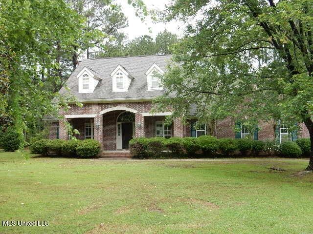 8 Auburn Ln, Hattiesburg, MS 39401 - cape cod house featuring brick siding and a front yard