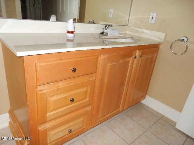 8 Auburn Ln, Hattiesburg, MS 39401 - bathroom featuring a sink, baseboards, and tile patterned floors