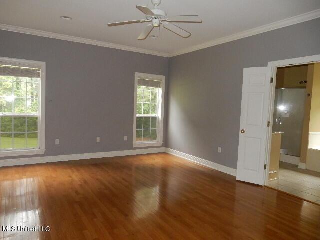 8 Auburn Ln, Hattiesburg, MS 39401 - empty room featuring wood finished floors, a ceiling fan, baseboards, and ornamental molding