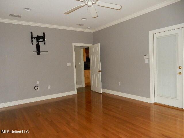 8 Auburn Ln, Hattiesburg, MS 39401 - unfurnished room with wood finished floors, baseboards, ornamental molding, and ceiling fan