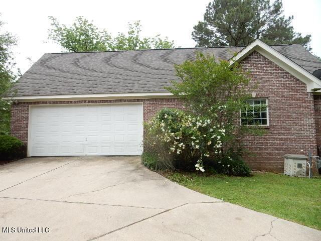 8 Auburn Ln, Hattiesburg, MS 39401 - view of front of home featuring brick siding, concrete driveway, an attached garage, and roof with shingles