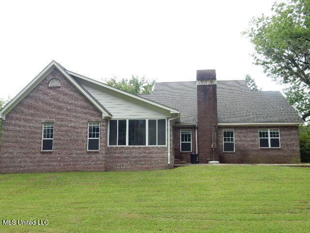 8 Auburn Ln, Hattiesburg, MS 39401 - rear view of house with brick siding, a yard, and a chimney