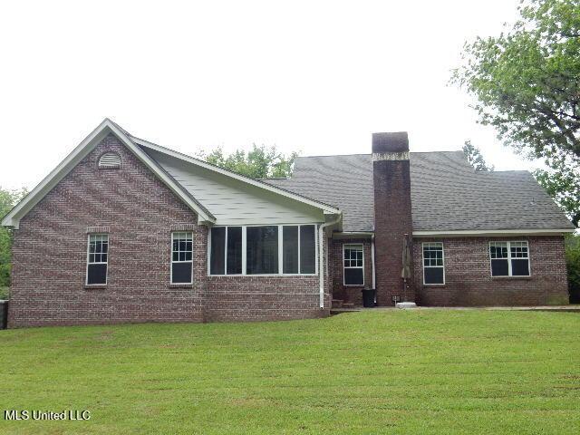 8 Auburn Ln, Hattiesburg, MS 39401 - rear view of property featuring brick siding, a lawn, and a chimney