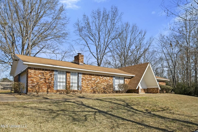 view of home's exterior with a garage and a lawn