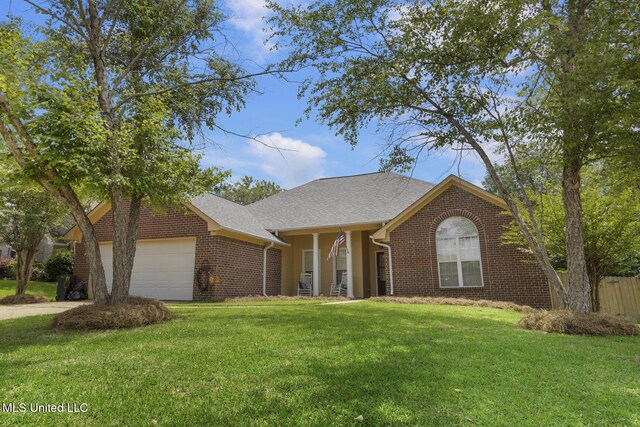 408 Abbey Woods, Brandon, MS 39047 - view of front of property featuring an attached garage and brick siding