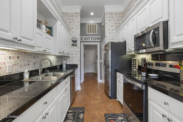 408 Abbey Woods, Brandon, MS 39047 - kitchen featuring appliances with stainless steel finishes, crown molding, a sink, white cabinetry, and backsplash