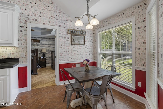 408 Abbey Woods, Brandon, MS 39047 - dining room with a chandelier, a wainscoted wall, vaulted ceiling, and baseboards